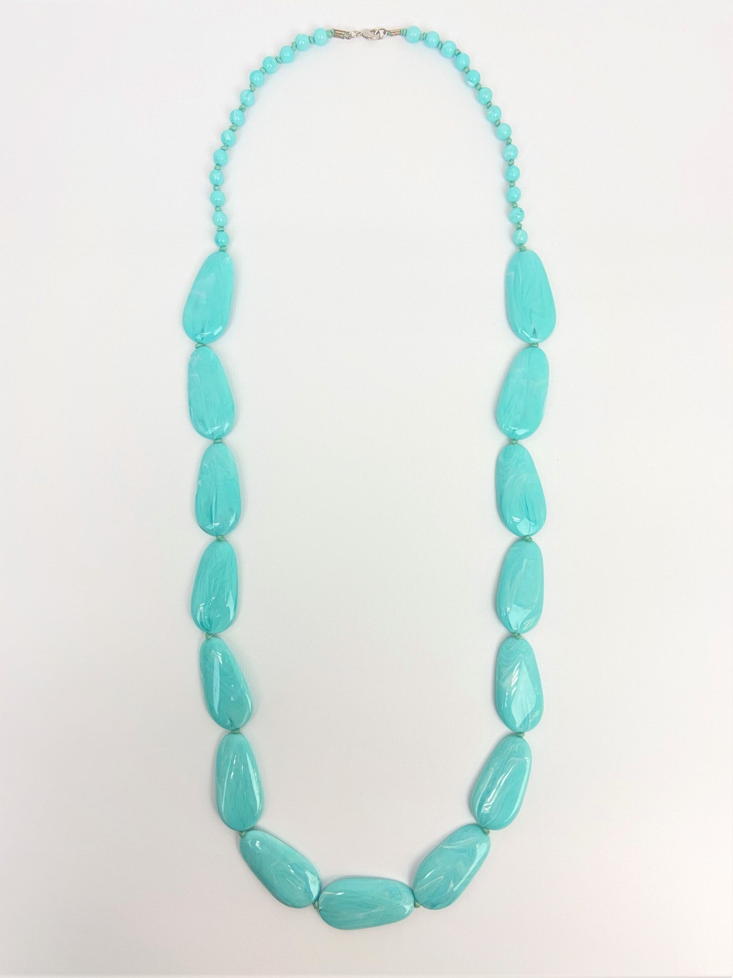 Poolside Pebble Necklace by Stage Jewellery with flat beads in cyan blue tones