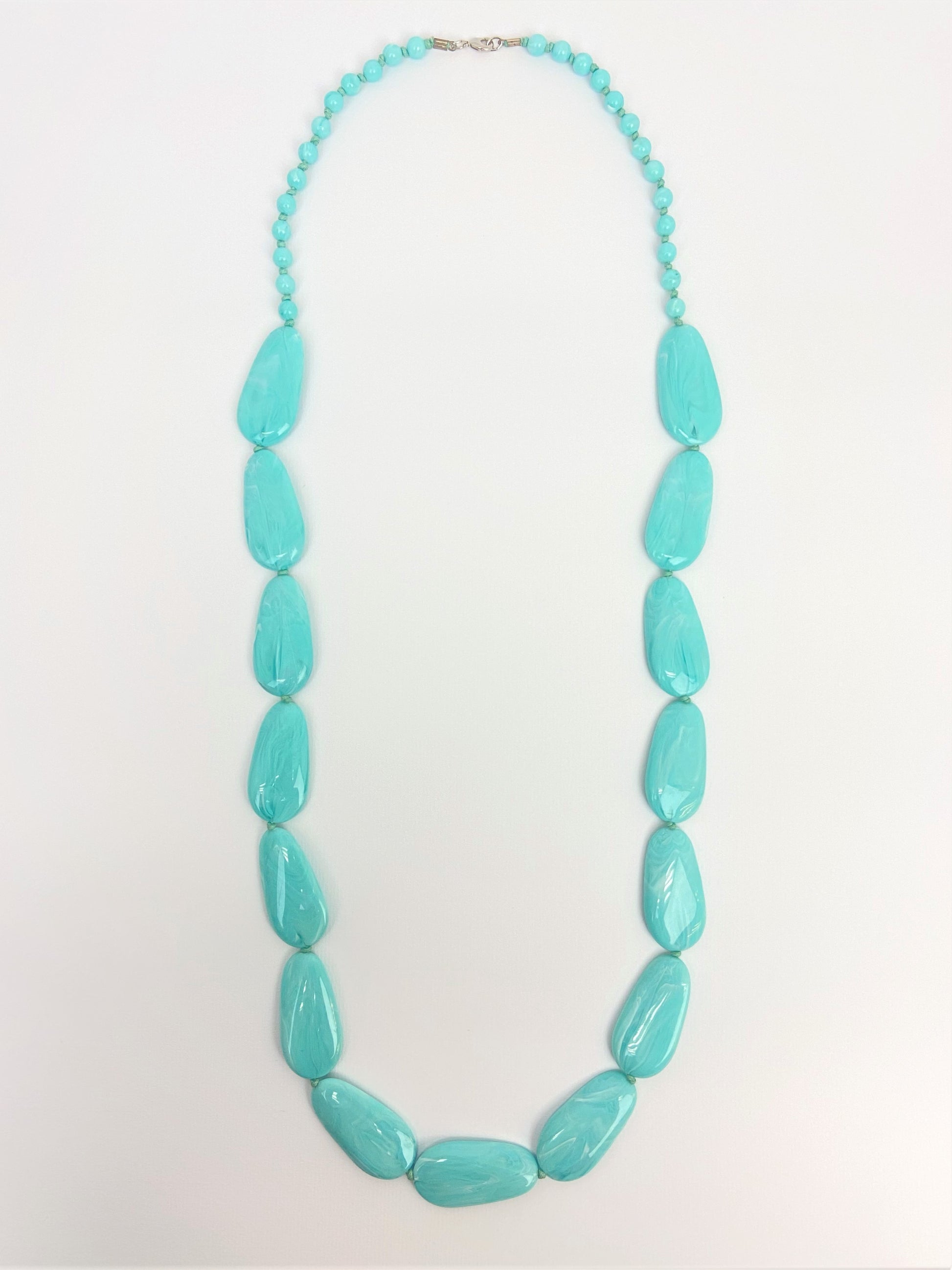 Poolside Pebble Necklace by Stage Jewellery with flat beads in cyan blue tones