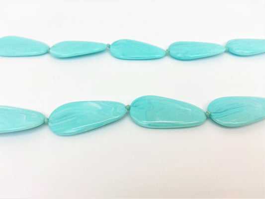 Poolside Pebble Necklace by Stage Jewellery with flat beads in cyan blue tones